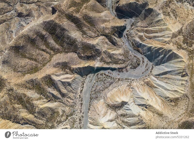 Drone view of dry rough terrain with rocky formations mountain nature landscape environment highland arid drought river scenery grass valley stone scenic