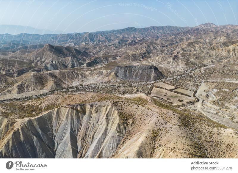 Drone view of dry rough terrain with rocky formations mountain nature landscape environment highland arid drought river scenery grass valley stone scenic