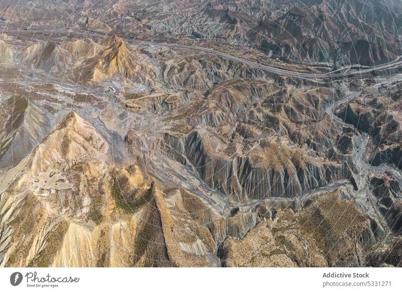 Drone view of dry rough terrain with rocky formations mountain nature landscape environment highland arid drought river scenery grass valley stone scenic