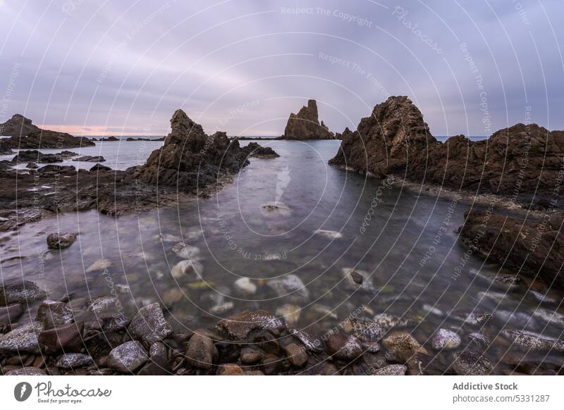 Amazing view of rocky seashore under dark cloudy sky formation cliff coast rough seascape nature ocean landscape scenic water spain stone highland scenery