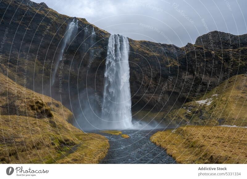 Amazing waterfall in rocky terrain landscape mountain woods iceland forest scenery seljalandsfoss kvernufoss flow stream nature scenic wild highland stone