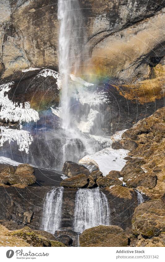 Cascade waterfall in rocky mountains cliff nature rough flow cascade formation geology landscape ravine stream rainbow scenic canyon surface uneven wild