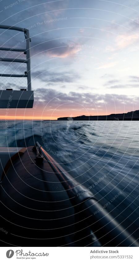 Amazing view of sea and speedspee boat during sundown wake motion transport sunset ocean sky nature picturesque cloudy seascape water idyllic scenic dusk wave