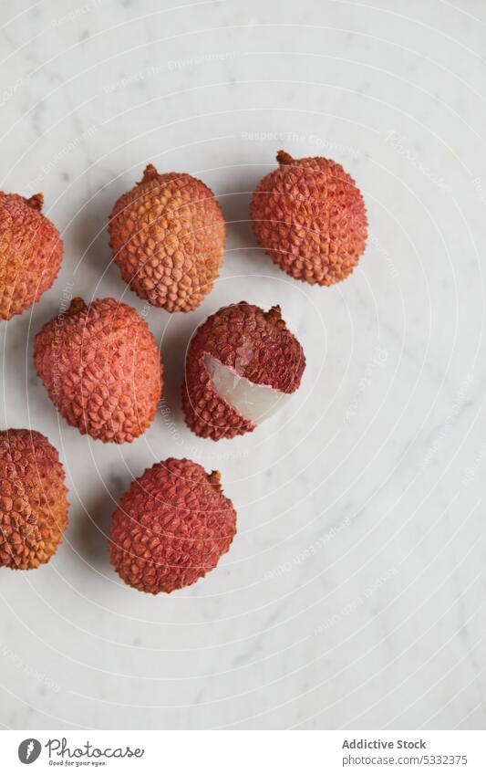 Fresh and cut open ripe lychee fruit on smooth surface delicious table healthy organic fresh juice natural vitamin beverage marble diet refreshment drink sweet