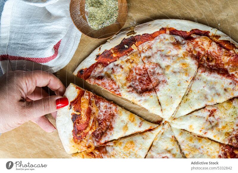 Fresh baked homemade pizza Italy hand margherita cheese cuisine dough eat eating woman anonymous faceless food fresh gourmet handmade herb italian lunch