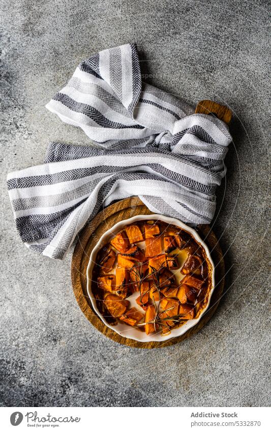 Sweet baked pumpkin cubes food board brown cook cooked cooking dish healthy herb herbs honey ingredient lunch meal organic pepper raw rosemary served set