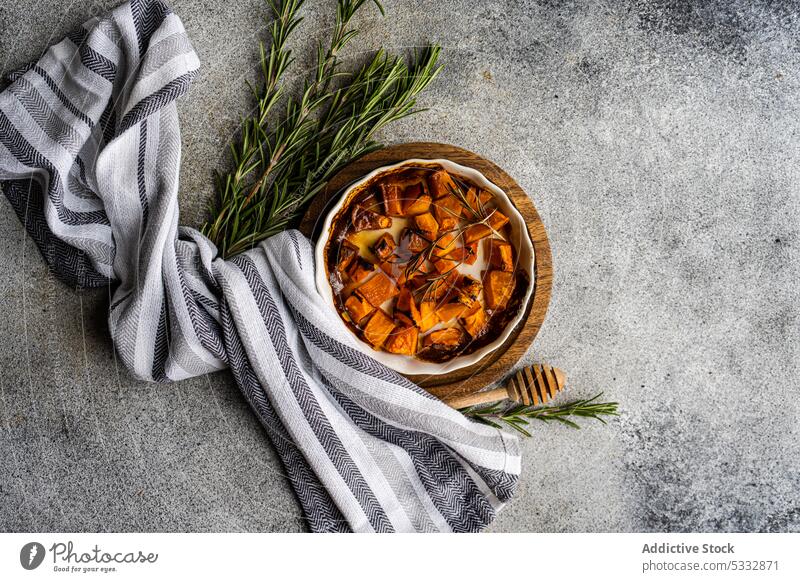 Sweet baked pumpkin cubes food board brown cook cooked cooking dish healthy herb herbs honey ingredient lunch meal organic pepper raw rosemary served set