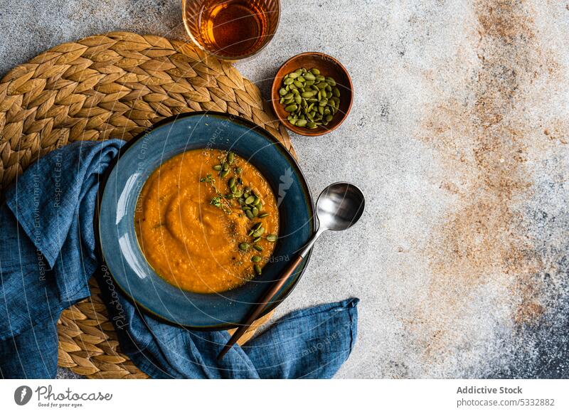 Tasty pumpkin cream soup in blue vintage ceramic bowl food ingredient dinner gourmet healthy herb lunch meal mug old styled organic raw rosemary rustic served