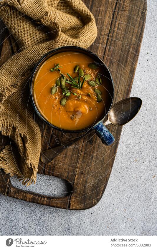 Tasty pumpkin cream soup in blue vintage ceramic bowl food ingredient dinner gourmet healthy herb lunch meal mug old styled organic raw rosemary rustic served