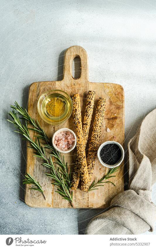 Cooking concept with rosemary herb food ingredient spice background board bowl bread bread stick cook cooking copy space gourmet kitchen oil overhead pepper