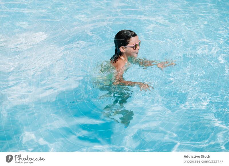 Little girl in swimming pool kid water childhood holiday vacation rest lying relax summer recreation resort adorable float summertime cute carefree enjoy