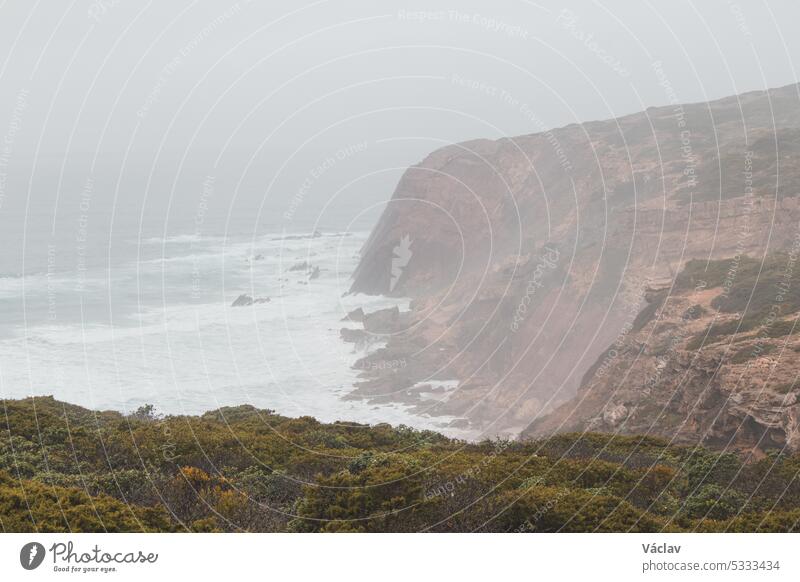 Stormy weather over the rocky cliffs of southwest Portugal's Algarve region. The power of the ocean. Wandering the Fisherman trail, Rota Vicentina splash stormy