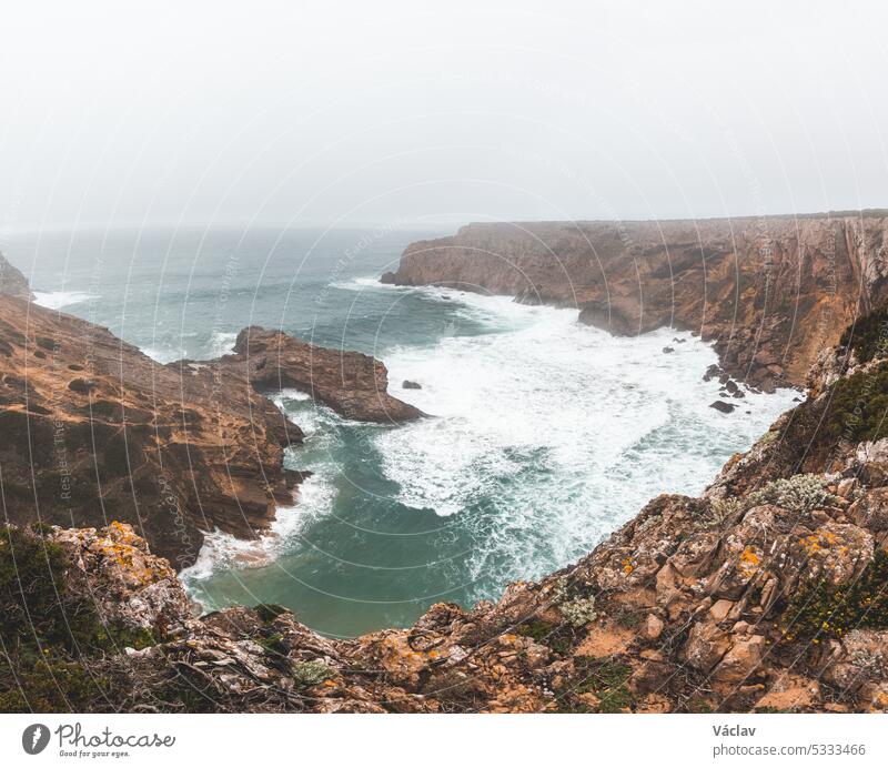 Rocky coastline of the Atlantic Ocean in the south-west of Portugal in the Algarve region. Exploring the beautiful rugged nature of the Fisherman Trail. Cape St. Vincent