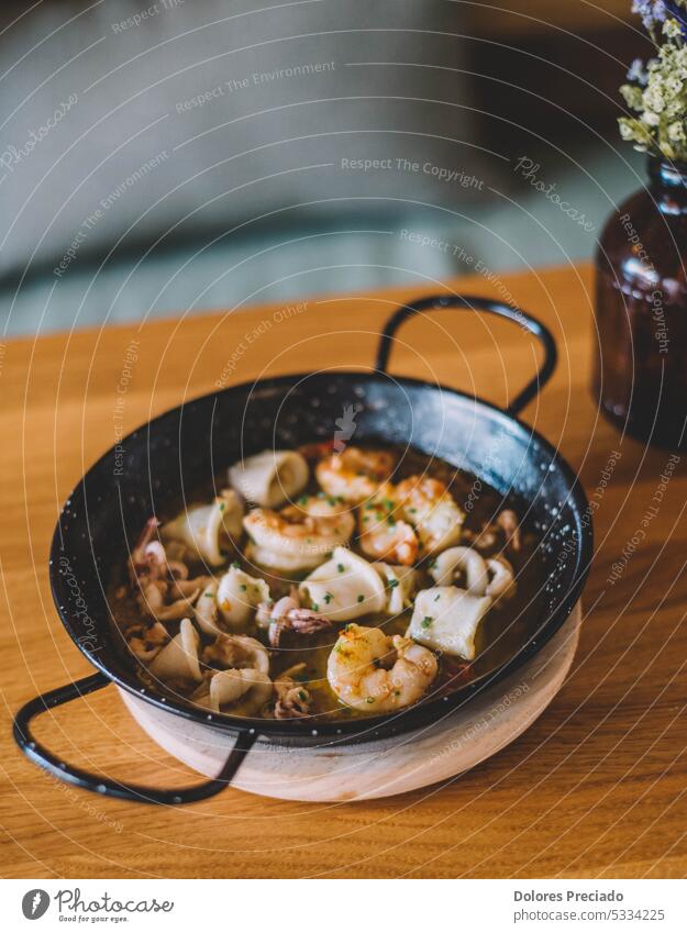 Squid and garlic prawns portion in a tapas bar ajillo appetizer background barbecue calamari chilli cooking cuisine delicious dinner dish food fresh fried