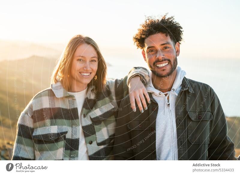 Cheerful diverse couple in countryside date positive together smile relationship happy cheerful love bonding multiracial multiethnic affection casual joy