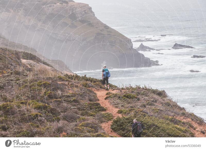 Portugal's western coastline of rocky cliffs and sandy beaches in the Odemira region. Wandering along the Fisherman trail on rainy days point horizon solitude