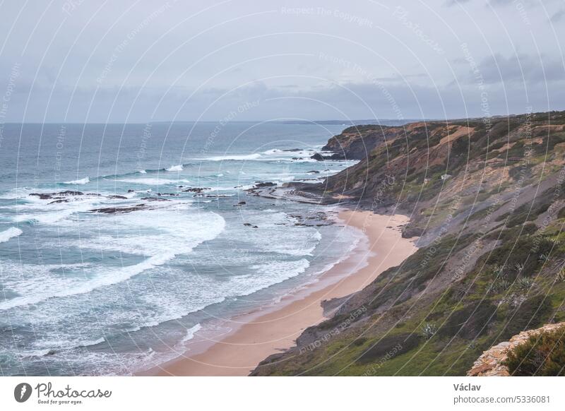 Portugal's western coastline of rocky cliffs and sandy beaches in the Odemira region. Wandering along the Fisherman trail on rainy days point horizon solitude