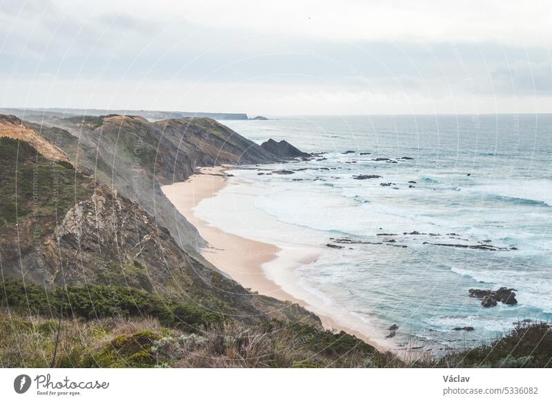 Portugal's western coastline of rocky cliffs and sandy beaches in the Odemira region. Wandering along the Fisherman trail on rainy days point horizon solitude