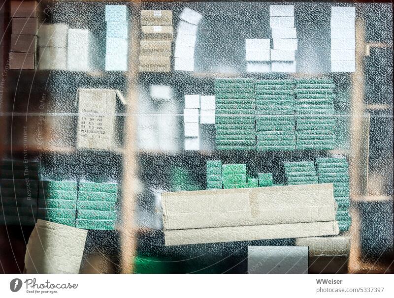 Behind the window you can see stacks of boxes and notebooks in muted colors Window Glass Stack Shelves stacked Stationery Notebooks Paper paperboard cartons