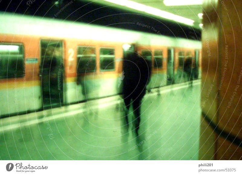 FFM underground. Commuter trains Underground Subsoil Station Hold Stop Motion blur Railroad Frankfurt Loneliness Green Perspective Human being Haste Orange