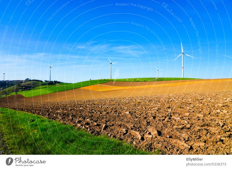 Environmentally friendly wind energy. Wind turbines at the edge of the field. wind power Pinwheel windmills Wind energy plant Renewable energy Energy industry