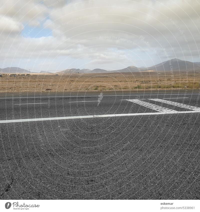 Fuerteventura road Street nobody Deserted Gray mountains Transport Exterior shot Colour photo Mountain Landscape Nature Day Copy Space top Sky Summer