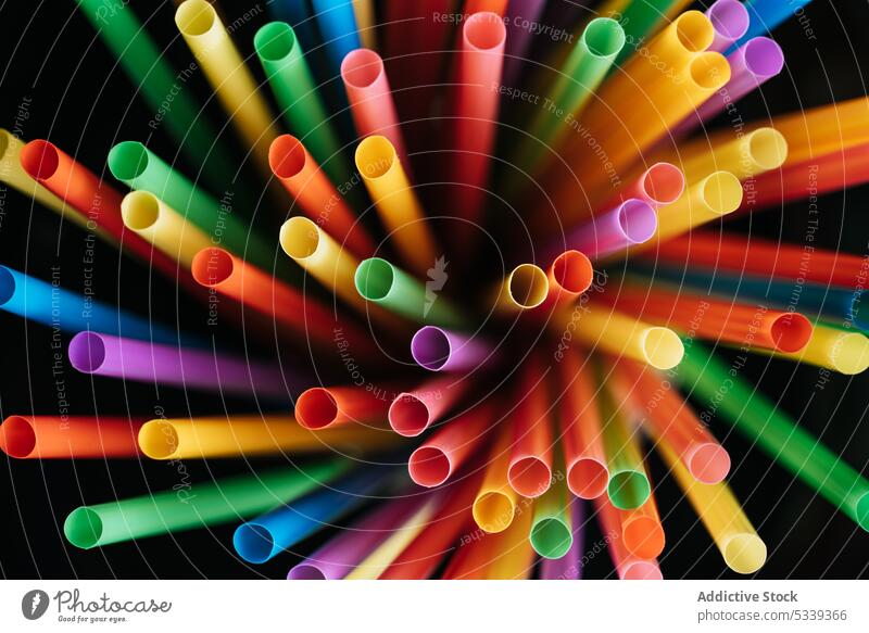 Bunch of colorful straws plastic texture bunch pipe beverage object art cocktail detail swirl bright vivid rainbow orange blue red yellow green pink purple