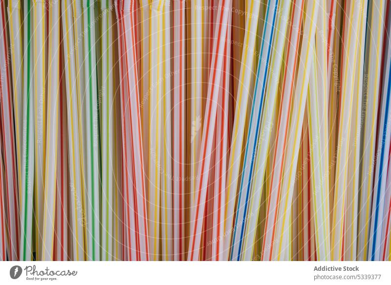 Bunch of colorful straws plastic texture bunch pipe beverage object art cocktail detail swirl bright vivid rainbow orange blue red yellow green pink purple