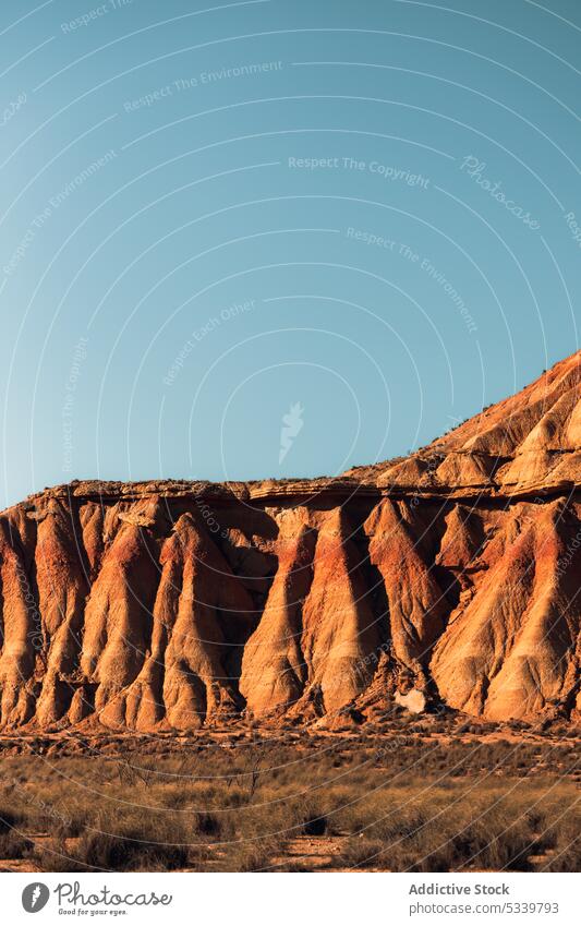 Rocky mountain ridge with rough rocks in desert nature geology uneven formation peak cliff range arid landscape rocky stone dry sandstone highland terrain hill