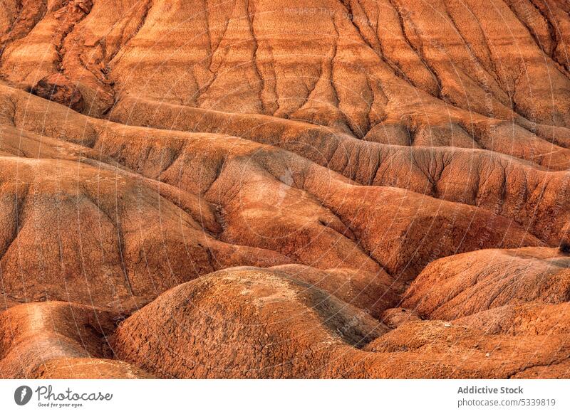 Sandy desert terrain with rocks rocky uneven nature rough background stone formation mountain geology dry landscape surface hill environment arid drought sand