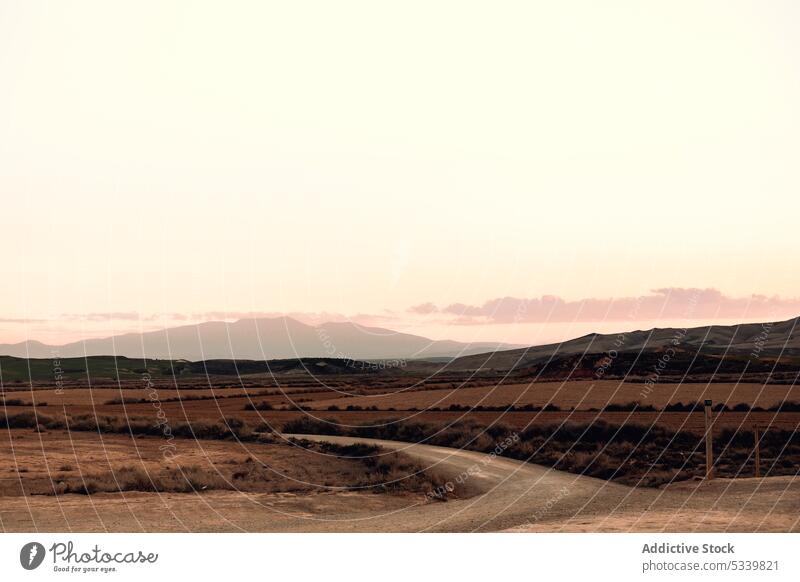 Road among desert surrounded by hills road valley nature path landscape bush mountain way terrain roadway environment scenic route dry sand navarra spain wild