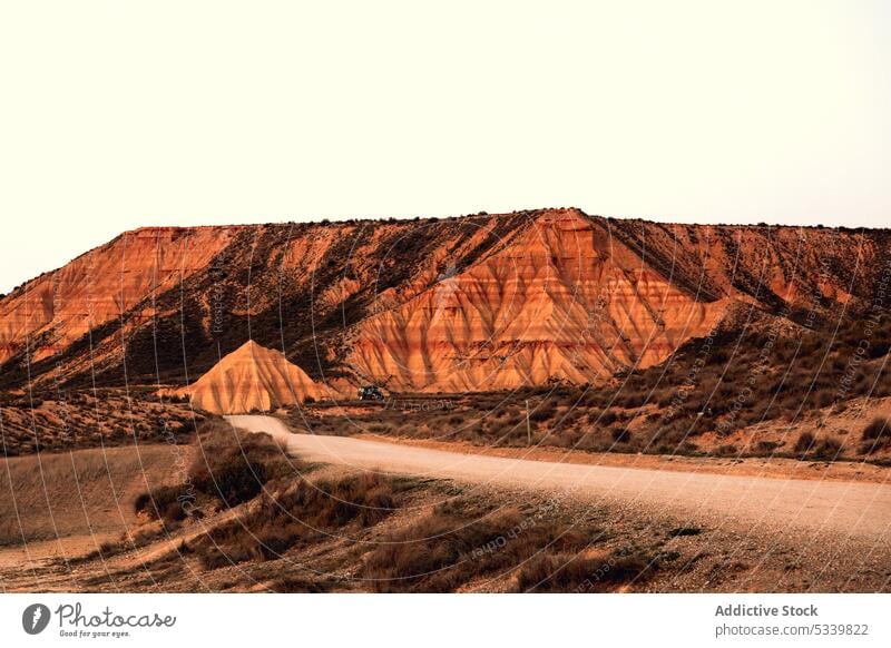 Road among desert surrounded by hills road valley nature path landscape bush mountain way terrain roadway environment scenic route dry sand navarra spain wild