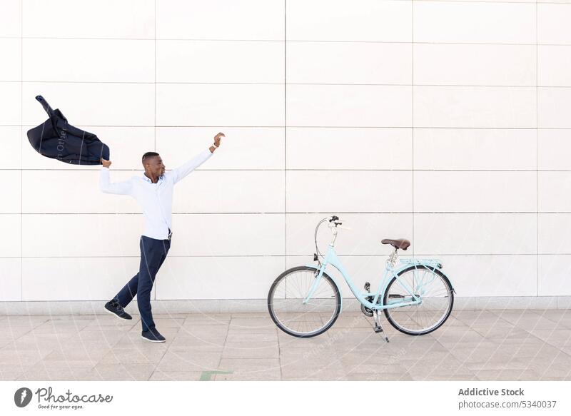 Black businessman raising hand with suit coat street entrepreneur employee formal well dressed african american executive professional arm raised black classy