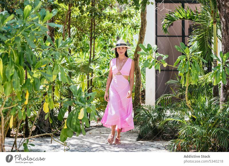 Confident woman standing in green forest with trees nature tropical style summer woods park dress female young tulum mexico mexican asian japanese calm sun