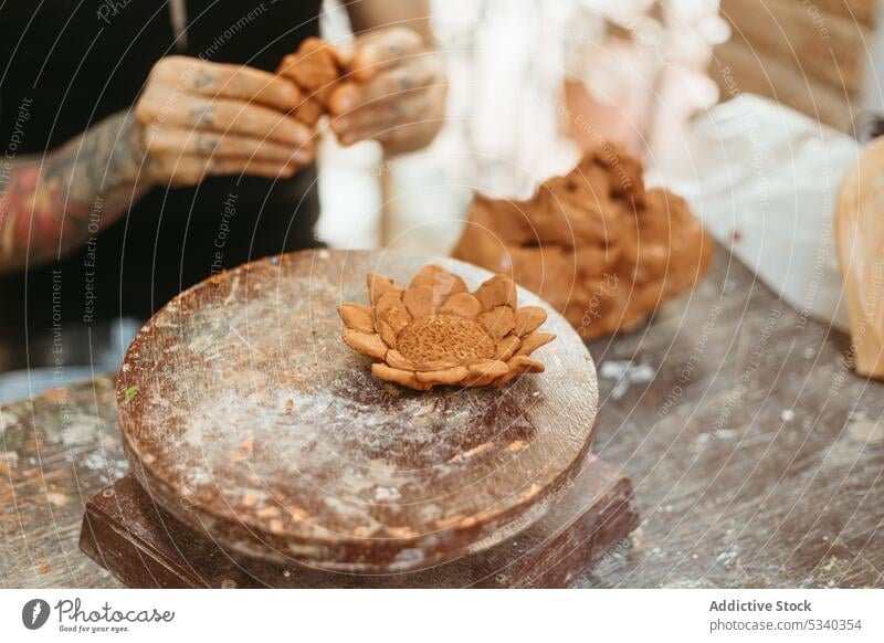 Potter working with clay in workshop man pottery create make workbench craftsman small business skill handmade ceramic creative art process artisan professional