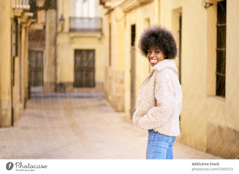 Happy ethnic young female with Afro hairstyle woman smile afro happy portrait positive cheerful glad long hair cozy optimist appearance lady toothy smile joy