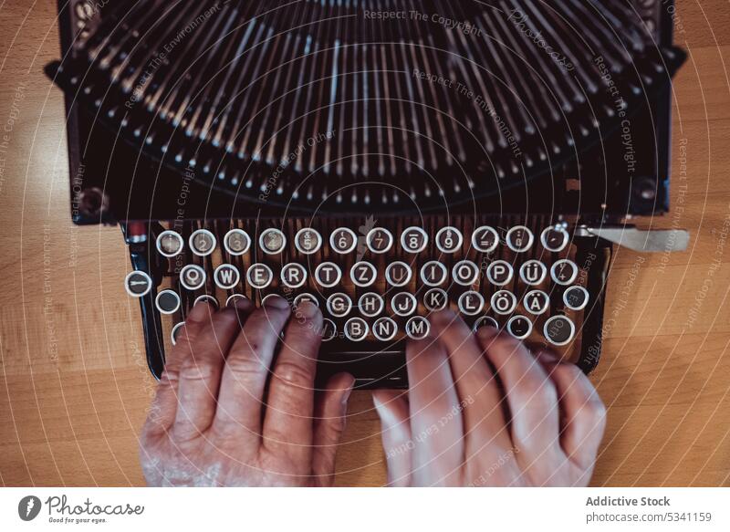 Crop hands using typewriter typing elderly person retro keys antique journalist machine vintage old author work job aged table desk mechanism ancient style