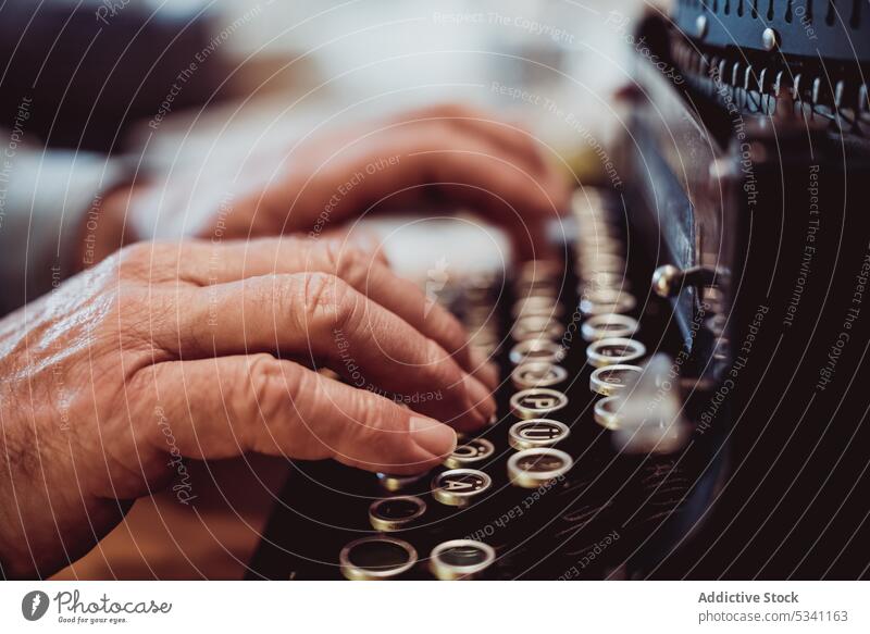 Crop hands using typewriter typing elderly person retro keys antique journalist machine vintage old author work job aged table desk mechanism ancient style