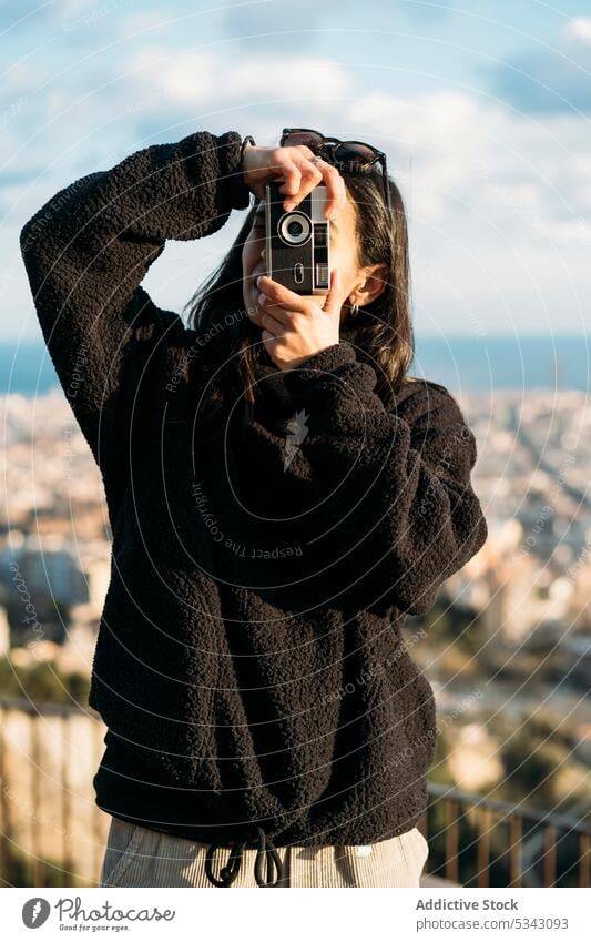 Unrecognizable woman taking photo on camera photographer take photo photo camera city summer retro memory urban hobby moment barcelona spain vacation travel