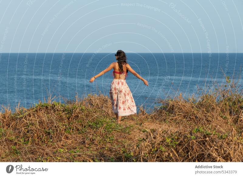 Carefree woman walking on grassy seashore vacation summer coast picturesque holiday nature admire mountain female puerto escondido oaxaca mexico beach travel