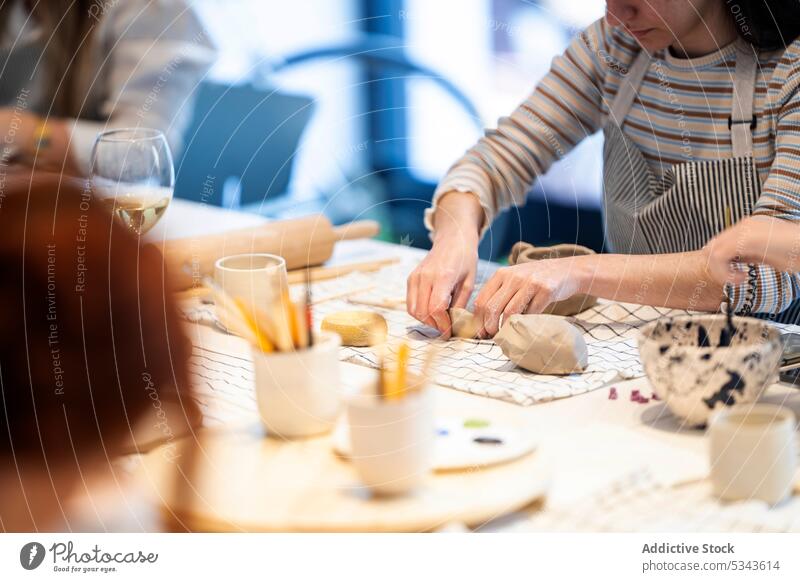 Crop women making clay cups during class together create workshop pottery table handmade handicraft creative hobby studio skill ceramic artist team craftswoman