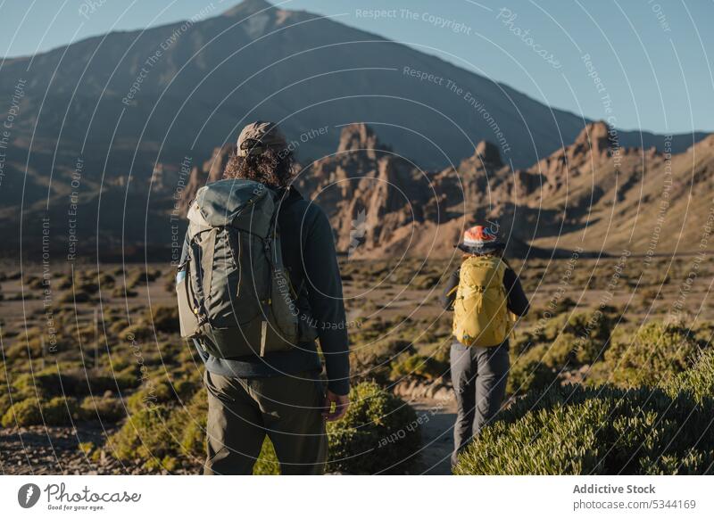 Unrecognizable traveler couple admiring mountains in nature hike tourist walk trip highland journey trekking adventure hill explore terrain tenerife spain