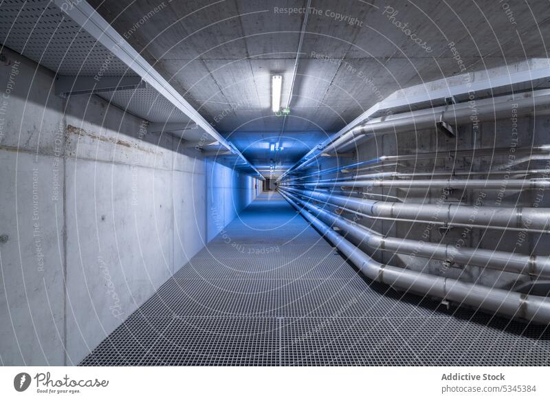 Empty underground tunnel with plumbing pipes corridor water gas pipeline drain system engineering hall basement warehouse boiler heat hvac ventilate electric