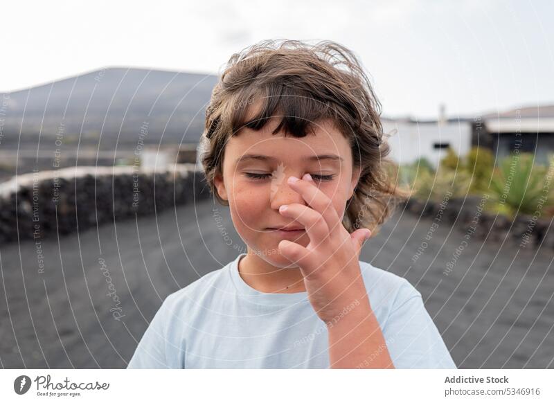 Closed eyes girl wiping face with hand child travel kid touch face little fresh nature daylight pleasure natural calm road innocent roadside lonely short hair