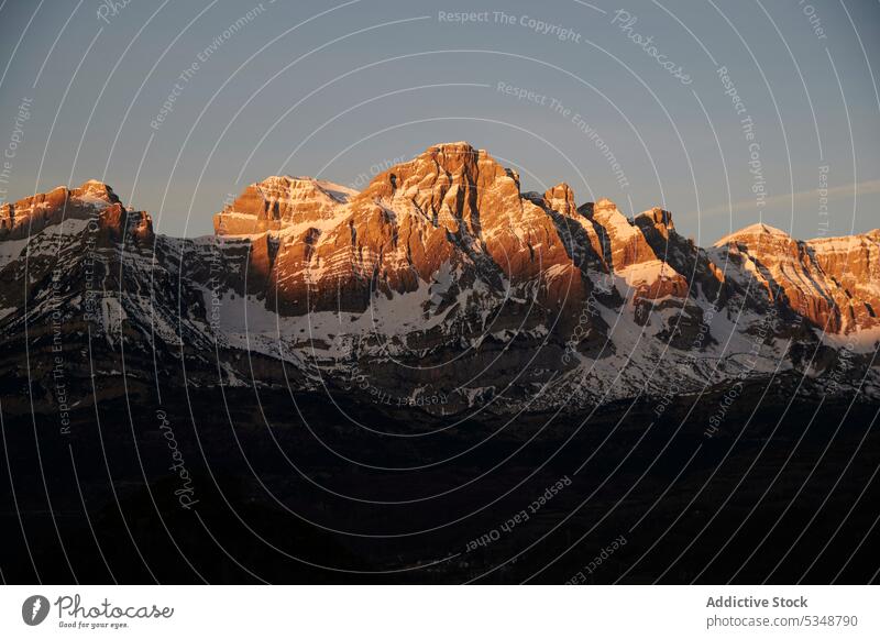 Amazing mountains in sunset light over city snow town evening landscape highland sky sundown picturesque blue sky pyrenees huesca spain majestic scenic nature