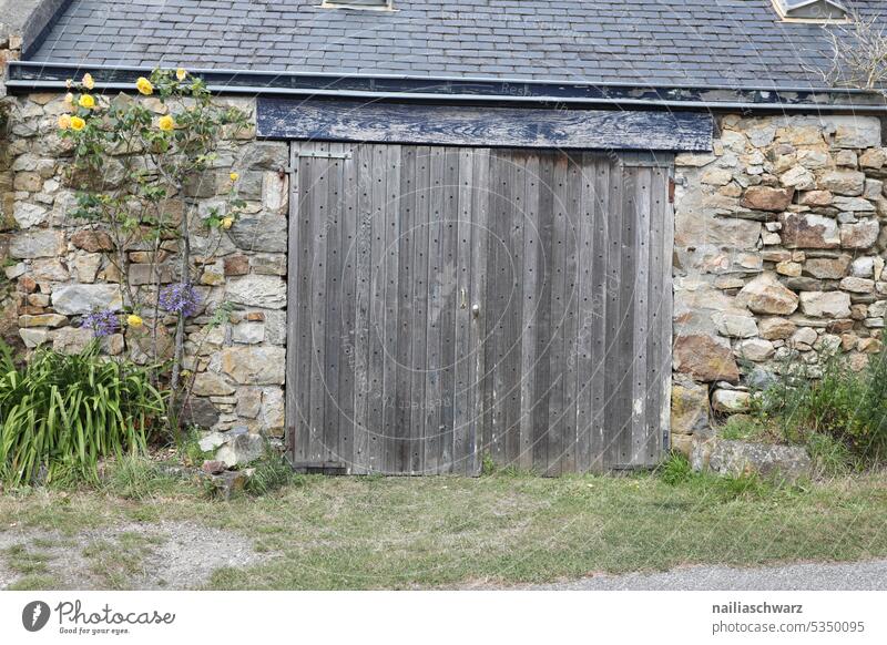 façade Barn Wooden boards Wooden door joiner's works Brown Metal Goal locked Lock too Old Historic Safety safeguarded Closed Deserted Padlock Exterior shot