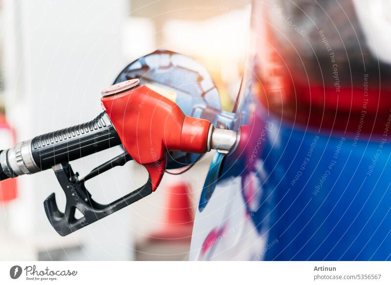 Car fueling at gas station. Refuel fill up with petrol gasoline. Petrol pump filling fuel nozzle in fuel tank of car at gas station. Petrol industry and service. Petrol price and oil crisis concept.