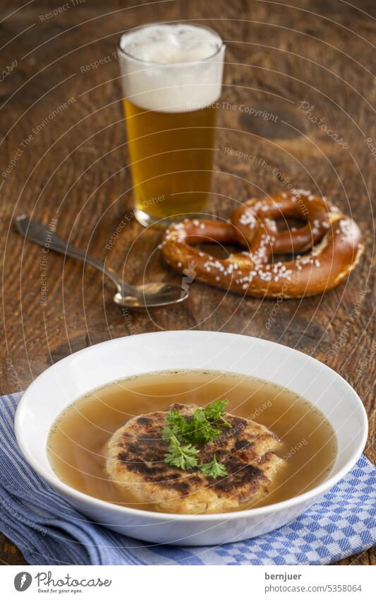 Austrian cheese dumpling soup on wood Kaspress dumpling soup Glass kaspres dumplings Roasted Kaspressknodel Dumpling filled Kitchen homemade Bread Table boil