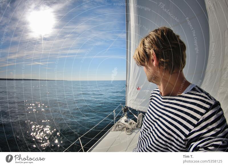 Sun sea sailboat Sailing Baltic Sea Sailboat Sky Ocean ship Man Striped sweater Water Sailing ship Freedom Vacation & Travel Adventure Navigation Horizon Summer