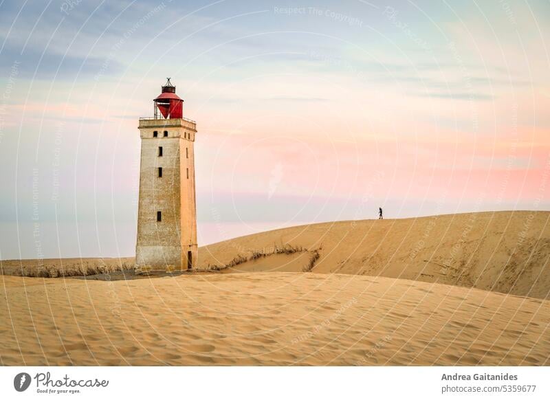 Silhouette of a man on the way to Rubjerg Knude lighthouse, morning at sunrise, horizontal duene sand dune Sand Wanderdüne Rubjerg Knude shifting dune